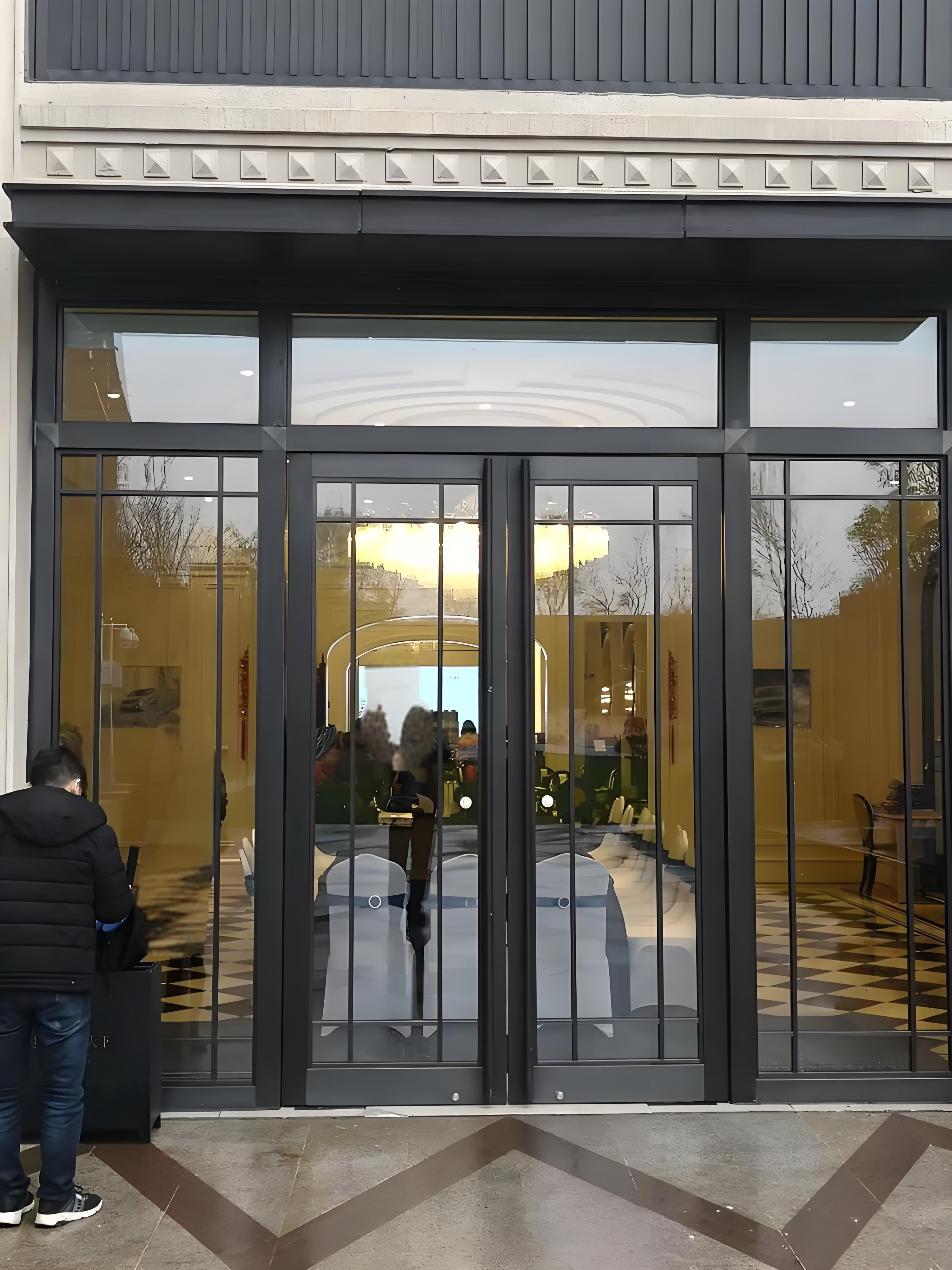 Black commercial spring door with grille